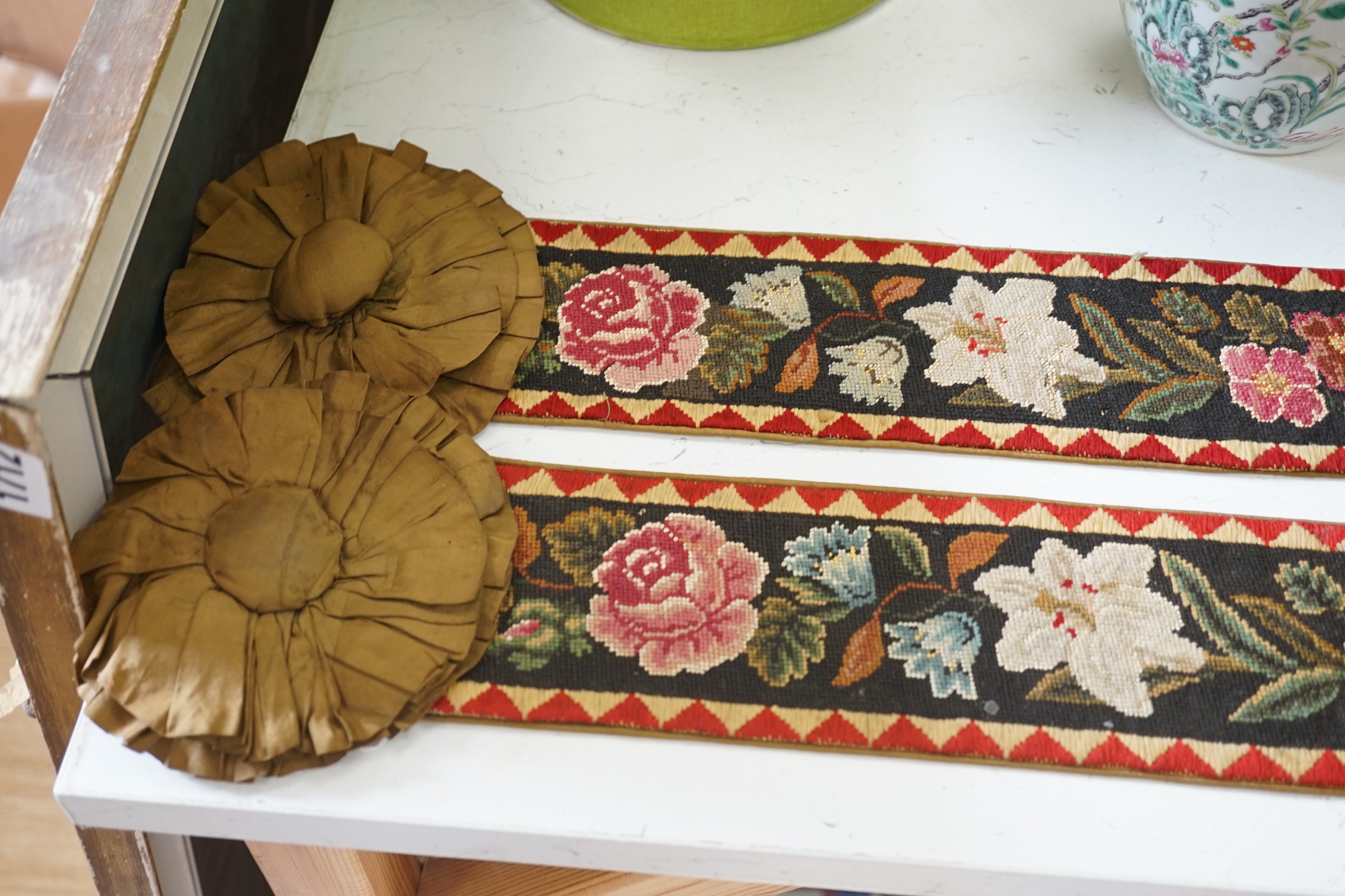 A pair of Victorian petit pointe embroidered bell pulls, 163cm including gilt metal hanger and silk rosette